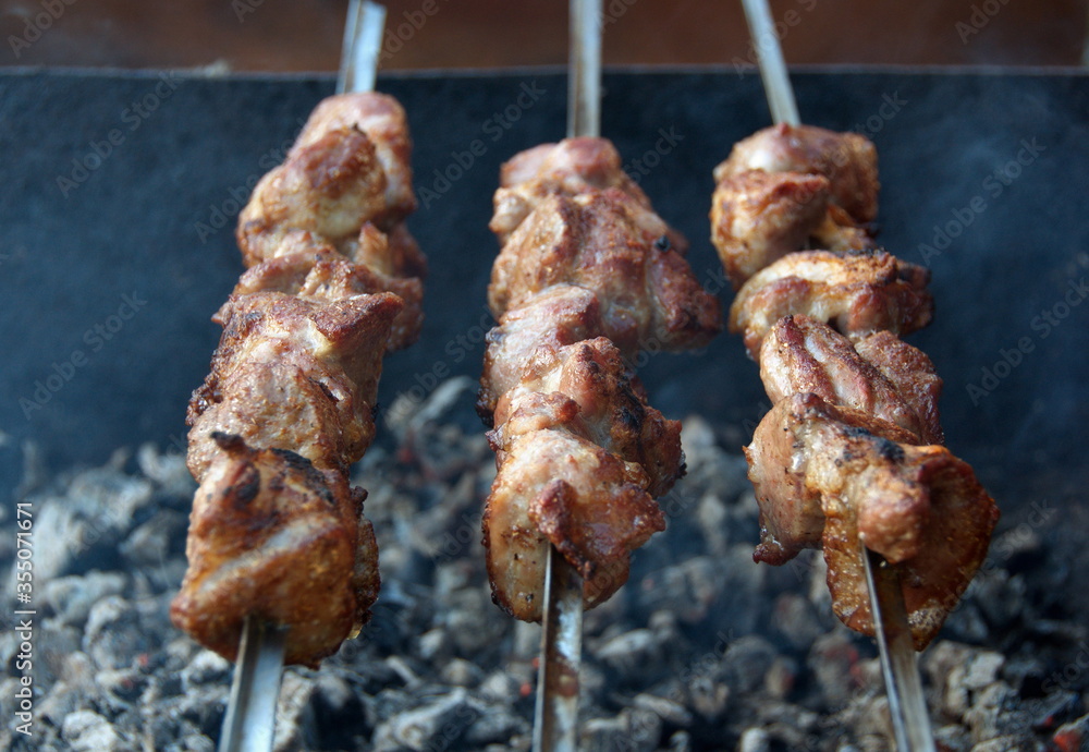 Cooking roasted over an open fire skewers of pork. shish kebab. shashlik. Cooking roasted over an open fire skewers of pork. shish kebab. shashlik.