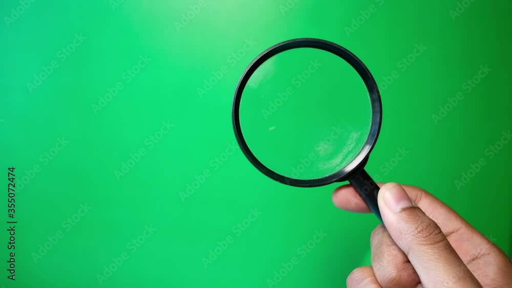 man's hand holding magnifying glass, Close up man's hand holding magnifying glass, Close up
