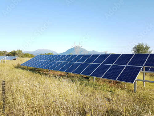 sollar panels on a field with grass in the morning photo