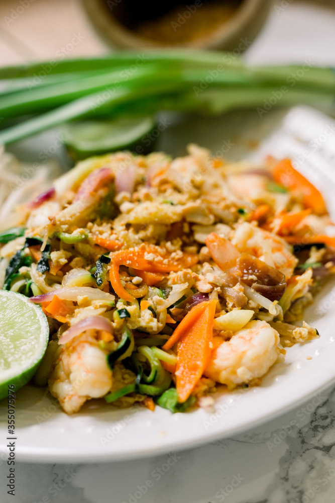 Delicious Shrimp Pad Thai Plate made with zucchini noodles, carrots, bean sprouts, and scallions. 