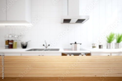 Wood table top on blur kitchen counter background.
