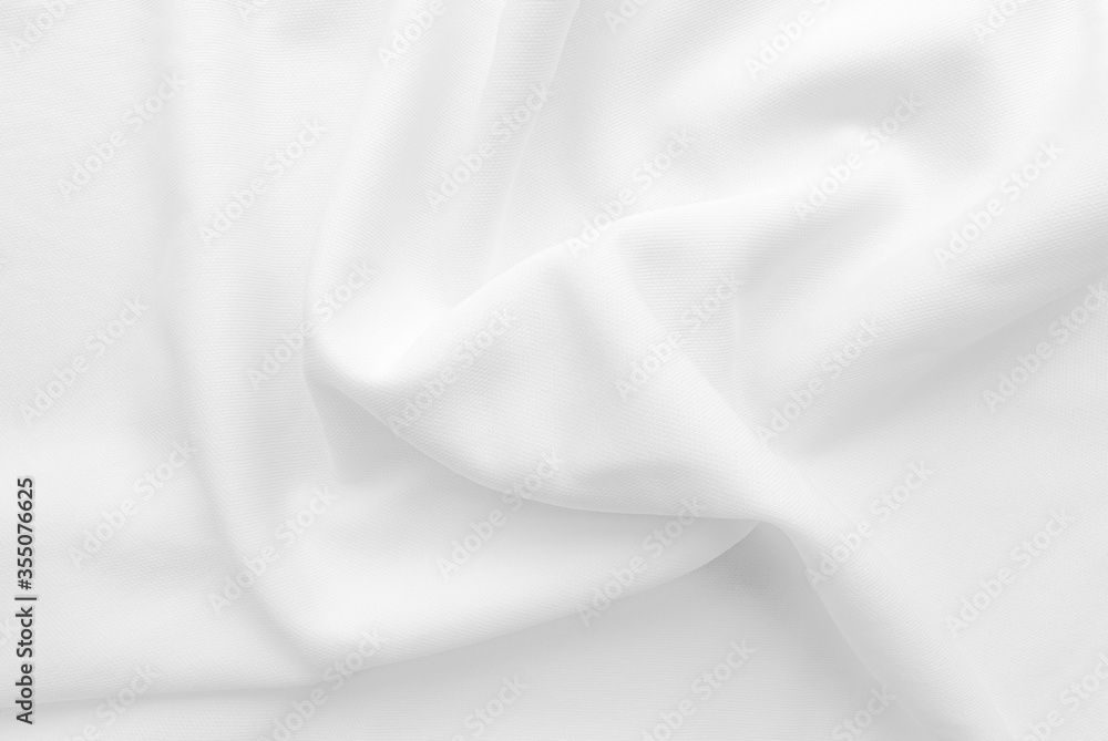 White abstract folded clothes background, fabric texture