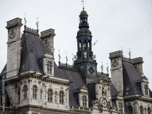 Renaissance style gorgeous building with dark roof, chimneys, clock, tower