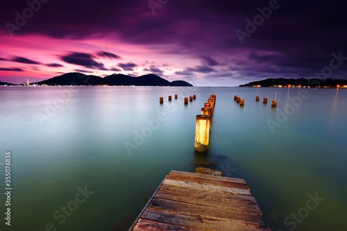 Beautiful sunset over the wooden jetty in marina island, pangkor photo