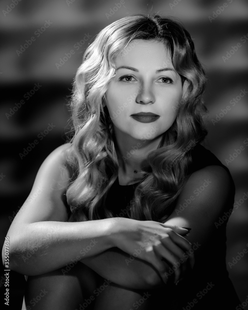 Beautiful young woman with curly blonde hair and bright makeup. image in black and white conversion Beautiful young woman with curly blonde hair and bright makeup. image in black and white conversion