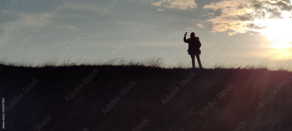 Fototapeta premium silhouette of a woman in a field