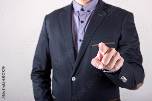 Man in business suit pointing his finger at you.