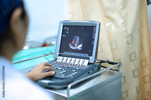 Physician making echocardiography for patient with heart disease photo