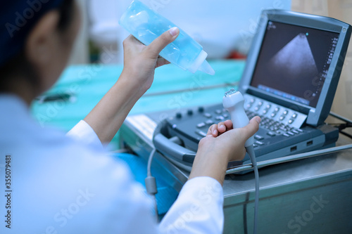 Physician squeeze medical gel to ultrasound probe of echocardiography machine