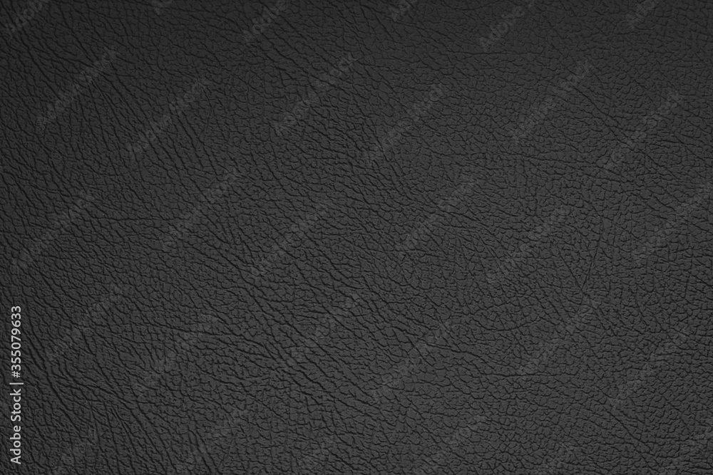 Black leather texture can be used as background. Artificial leather close-up