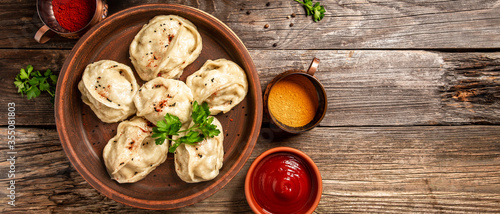 The concept of oriental cuisine. Uzbek food Manti or manty dumplings restaurant concept. Homemade Uzbek dish. recipe background. space for text. top view photo