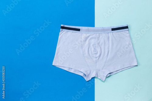 Light men's boxers on a two-color background.