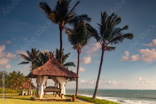Coconut trees and pavilion on the beach of Bali Indonesia