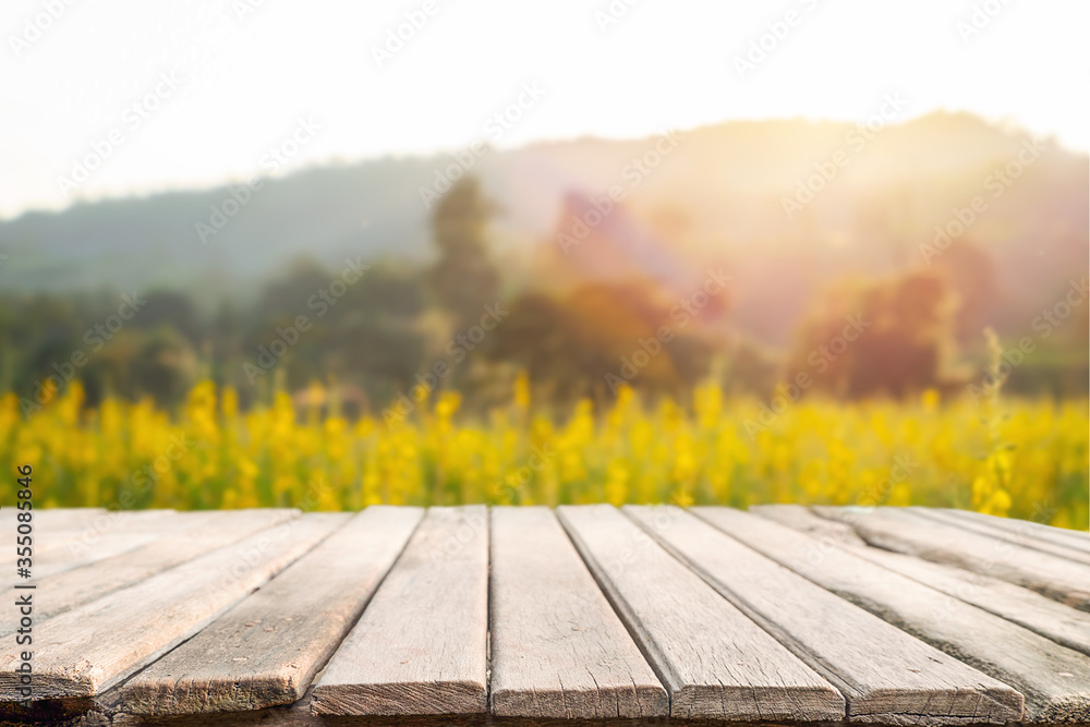 Empty wooden desk space platform and blurred field or farm background for product display montage. Empty wooden desk space platform and blurred field or farm background for product display montage.