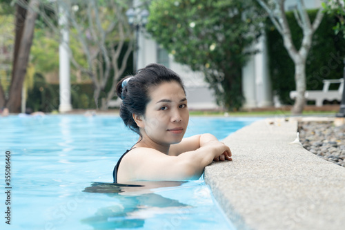 Beautiful Asian woman in swimming pool