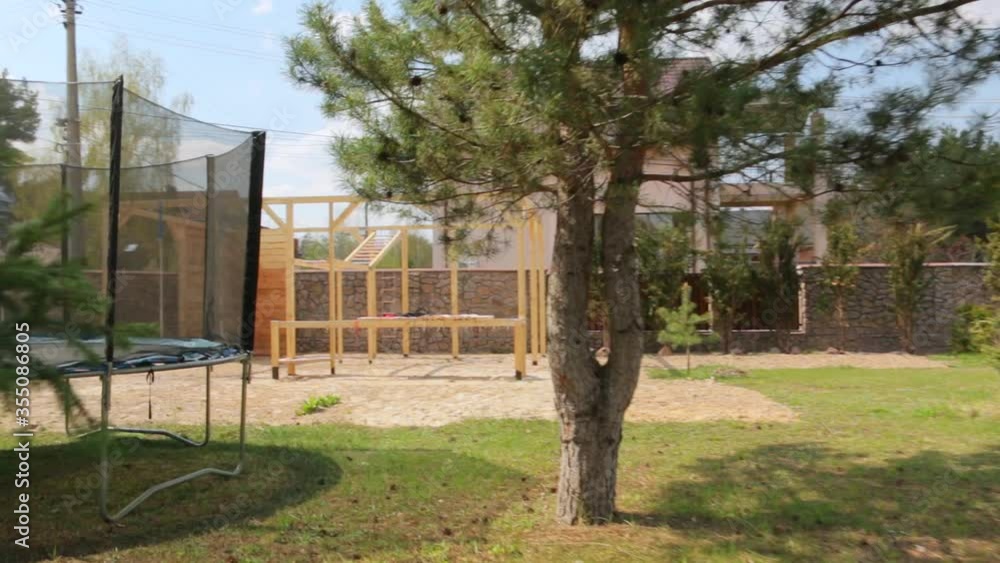 Outdoors sport facilities playground on backyard workout trees trampoline sports equipment camera movement Outdoors sport facilities playground on backyard workout trees trampoline sports equipment camera movement