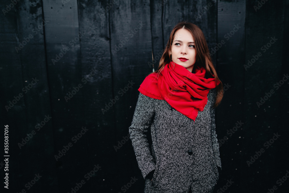Pretty lady in festive dress points to place for text on black background Pretty lady in festive dress points to place for text on black background