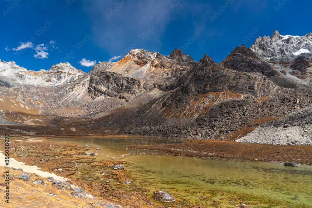 Fototapeta premium Small lake surrounded by Himalaya mountains range after crossing Renjo la pass, Everest base camp trekking route, Nepal