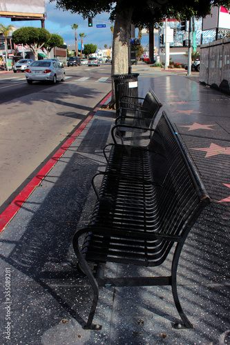 Los Angeles, California, USA. October 16, 2016. A bus stop with a bench at Hollywood Boulevard and the intersection of N Gower St.
