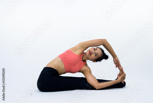 Fototapeta Naklejka Na Ścianę i Meble -  Asian women practicing yoga on a white background