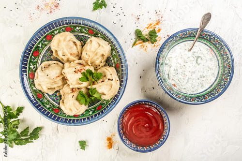 Traditional Turkish Manti with yoghurt. The concept of oriental cuisine. Uzbek food Manti or manty dumplings photo