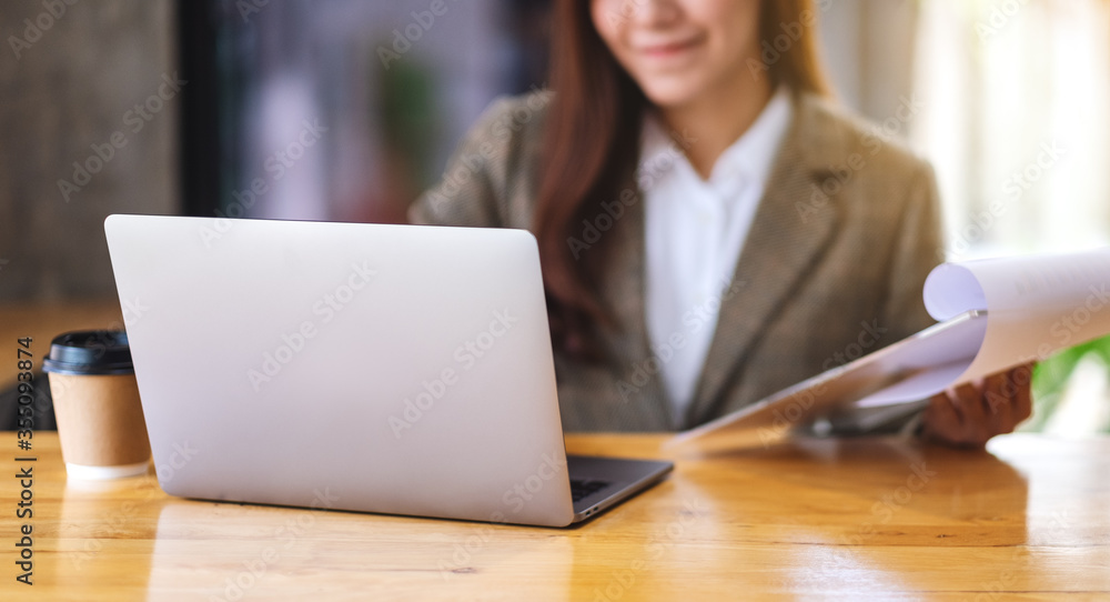 Closeup image of an asian businesswoman using laptop computer while working in office Closeup image of an asian businesswoman using laptop computer while working in office