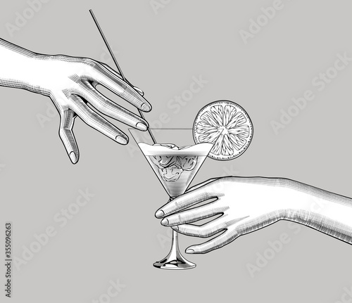 Female hands holding a cocktail with a orange slice