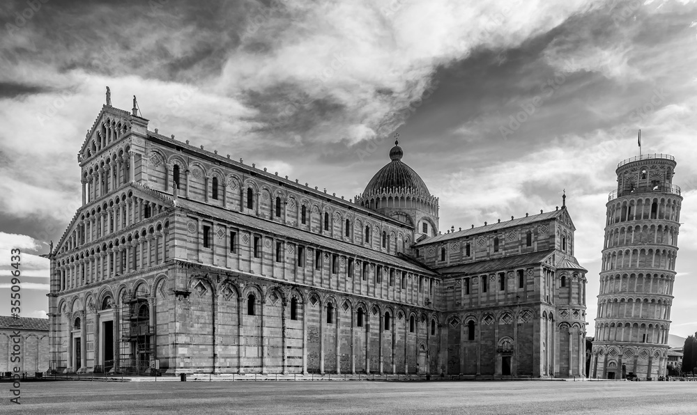 Black and white view of the famous Piazza dei Miracoli square and the leaning tower, in the historic center of Pisa, Italy, completely deserted due to the Covid-19 coronavirus pandemic