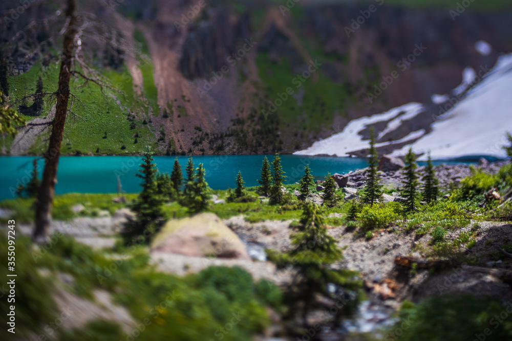Fototapeta premium Tilt shift lens used to give appearance of miniature blue lake and forest. 