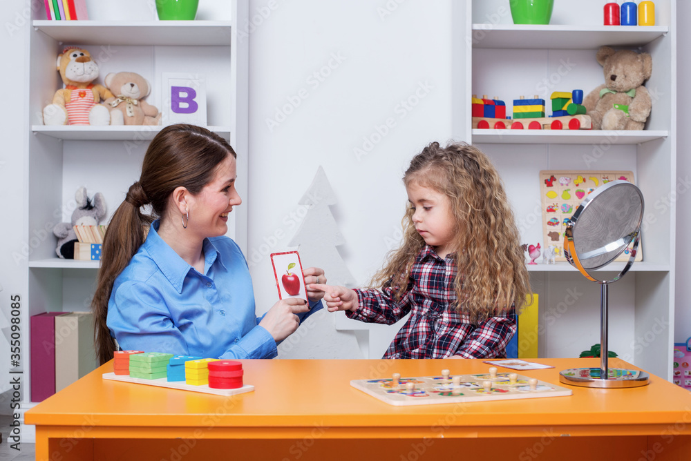 Fototapeta premium Child with speech therapist on therapy