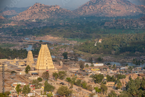 a view of Virupaksha Temple, a famous and ancient Shiva Temple built by Vijayanagara Rulers in 7th Century AD, shot from Mathanga Hill just before sunrise. Hampi, Karnataka, India. photo