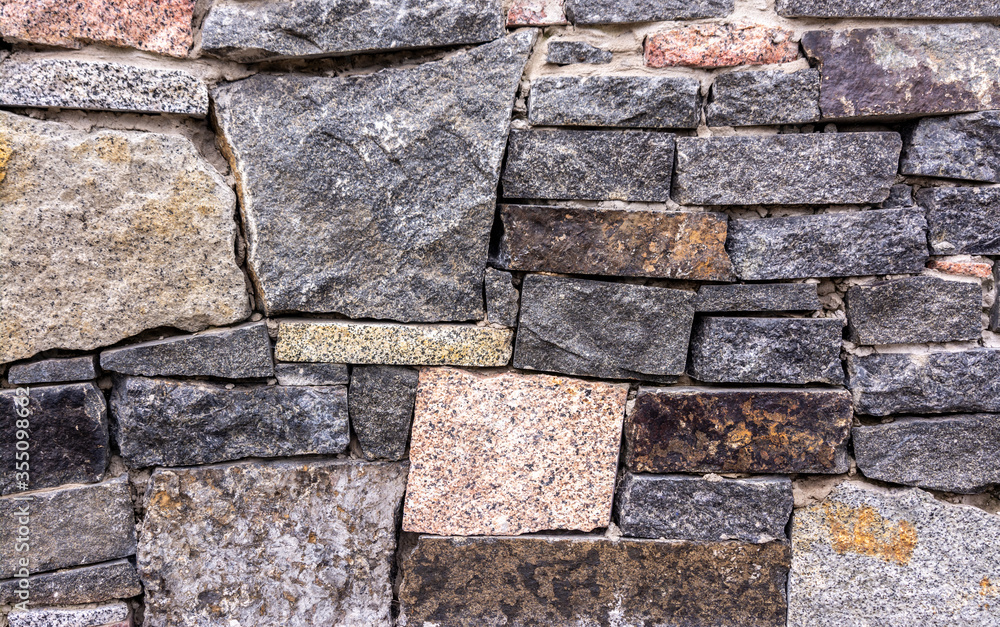 Fototapeta premium The texture of the stone wall. Part of a stone wall, for background or texture