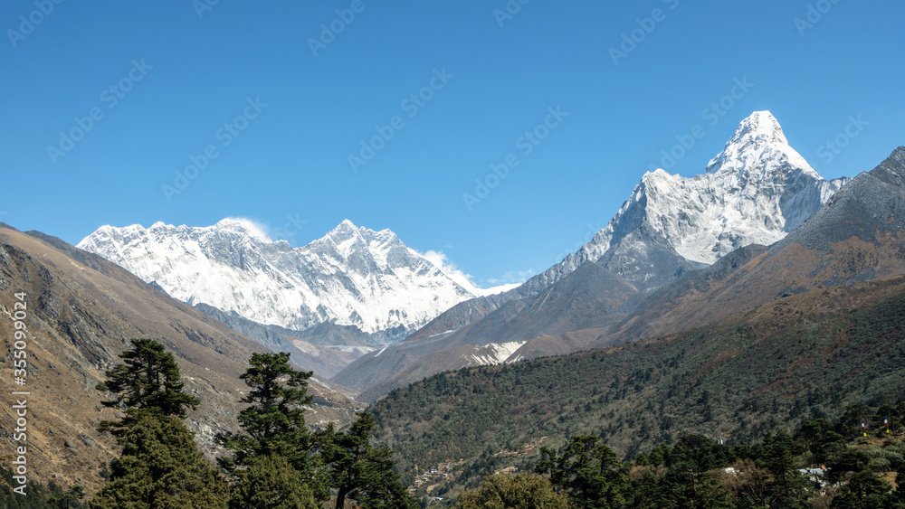 View of Mount Everest, Lhotse and Ama Dablam peaks with a clear blue sky 
