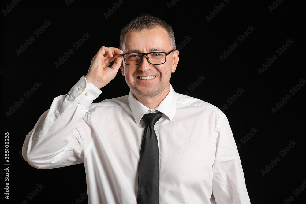 Portrait of handsome businessman on dark background Portrait of handsome businessman on dark background