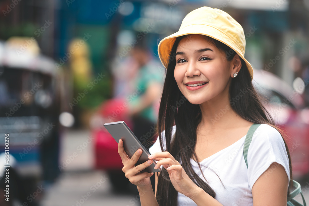 Asian traveller woman outdoor with smartphone on day Bangkok city.