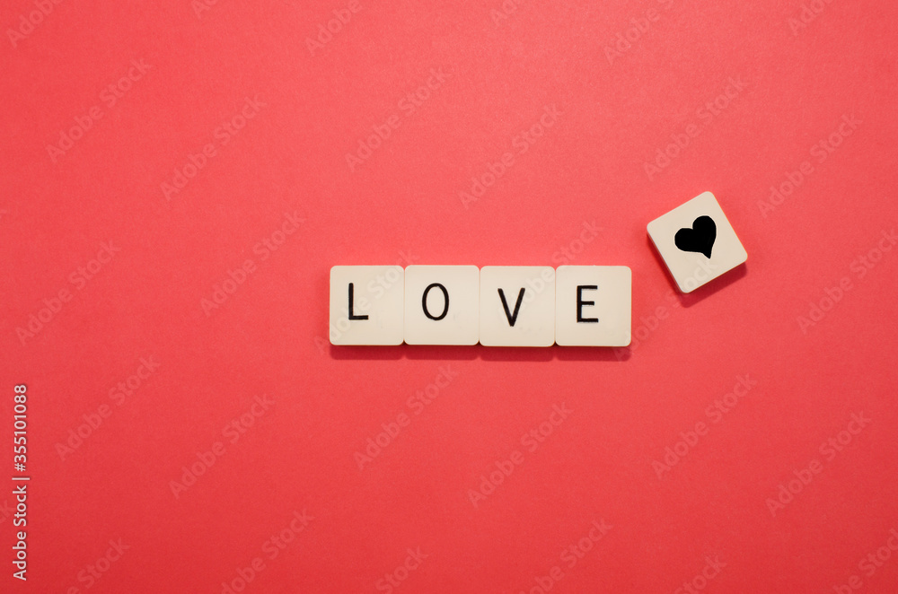 red background with pieces with the word love and heart symbol. red background with pieces with the word love and heart symbol.