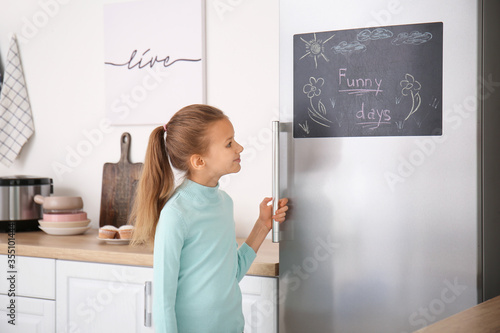 Little girl near chalkboard...