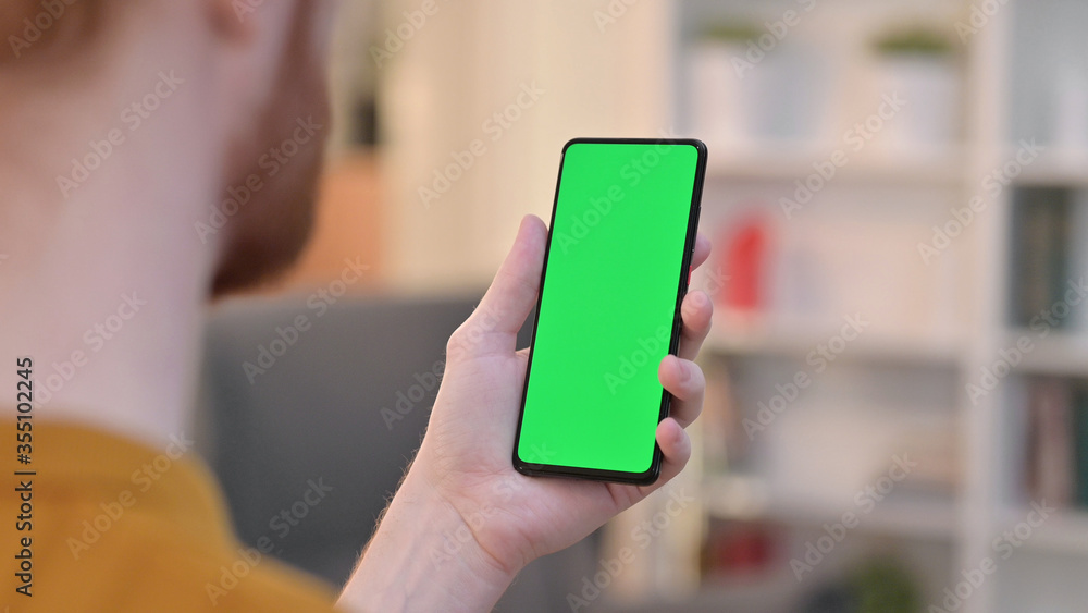 Rear View of Man using Smartphone with Chroma Key Screen Rear View of Man using Smartphone with Chroma Key Screen