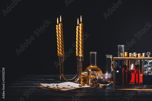 Potions and candles on alchemist's table photo