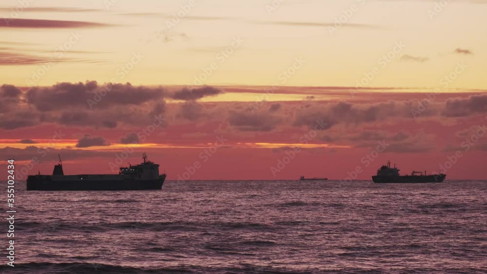 Transport ship at sea. Beautiful orange sunset. Evening. Shipping by sea. Container ship. Transport ship at sea. Beautiful orange sunset. Evening. Shipping by sea. Container ship.