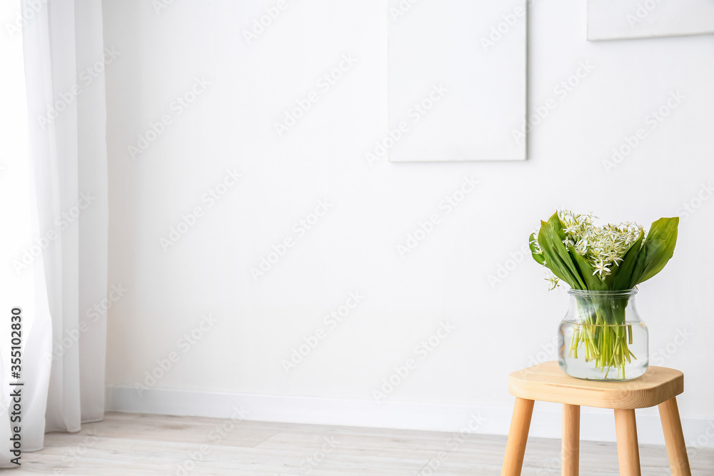 Beautiful flowers on stool in living room Beautiful flowers on stool in living room