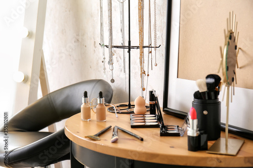 Makeup cosmetics on table in modern dressing room