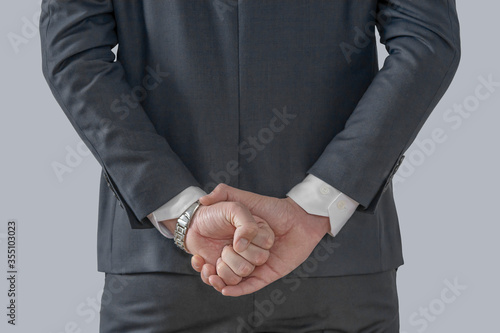 Businessman holding his hands behind his back