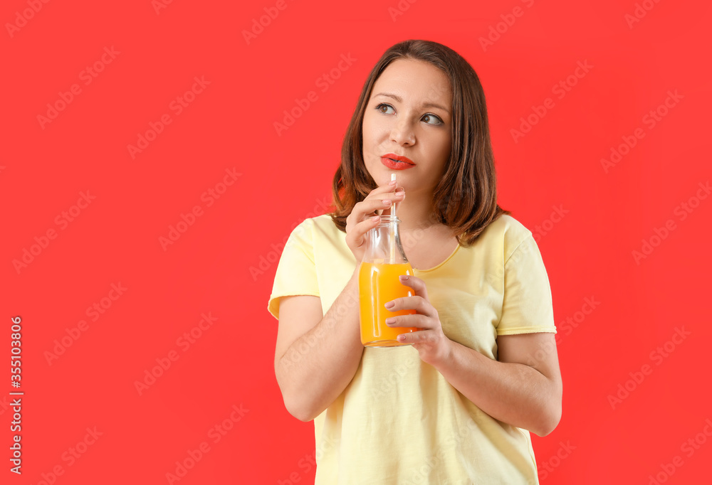 Beautiful young woman drinking juice on color background Beautiful young woman drinking juice on color background