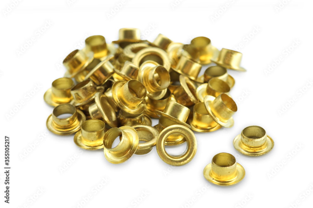 Close-up of brass eyelet, Accessery for leather work, Golden metal, Isolated on white background. Close-up of brass eyelet, Accessery for leather work, Golden metal, Isolated on white background.