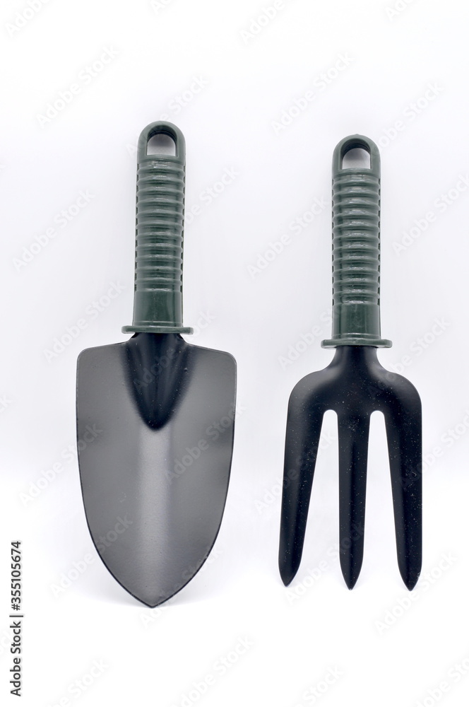 black garden shovel and fork isolated on white background. black garden shovel and fork isolated on white background.