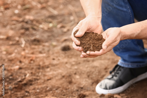 Man testing rich soil outdoors