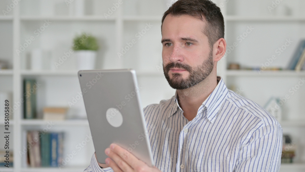 Portrait of Ambitious Young Man using Tablet Portrait of Ambitious Young Man using Tablet