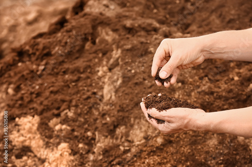 Man testing rich soil outdoors