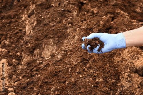 Man testing rich soil outdoors